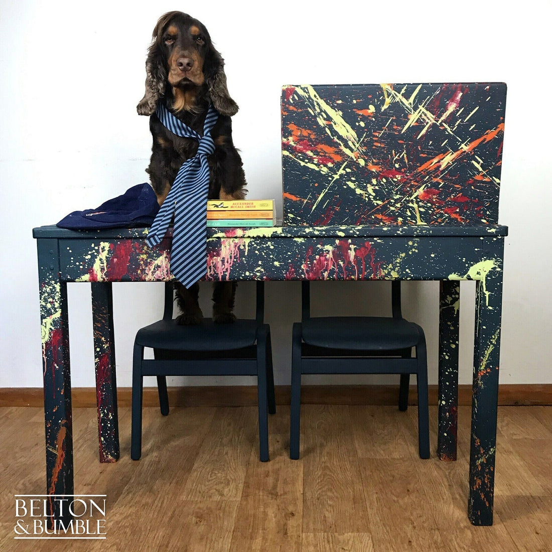 Upcycled children’s desk and chairs with bold paint splatter design in blue, red, yellow, and orange by Belton & Bumble.