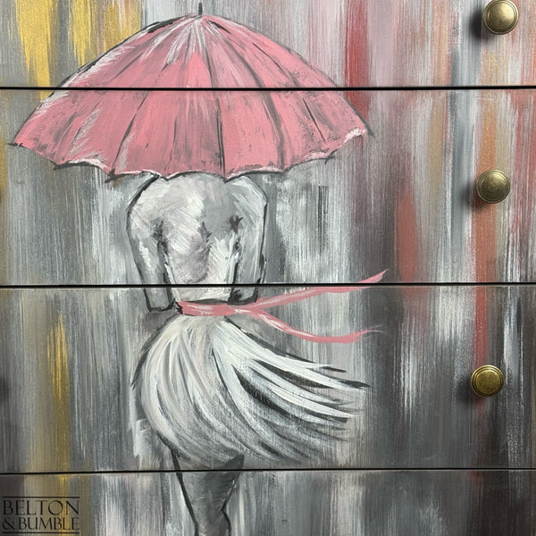 Close-up of painted figure and pink umbrella on drawers, textured brushwork in grey and red.
