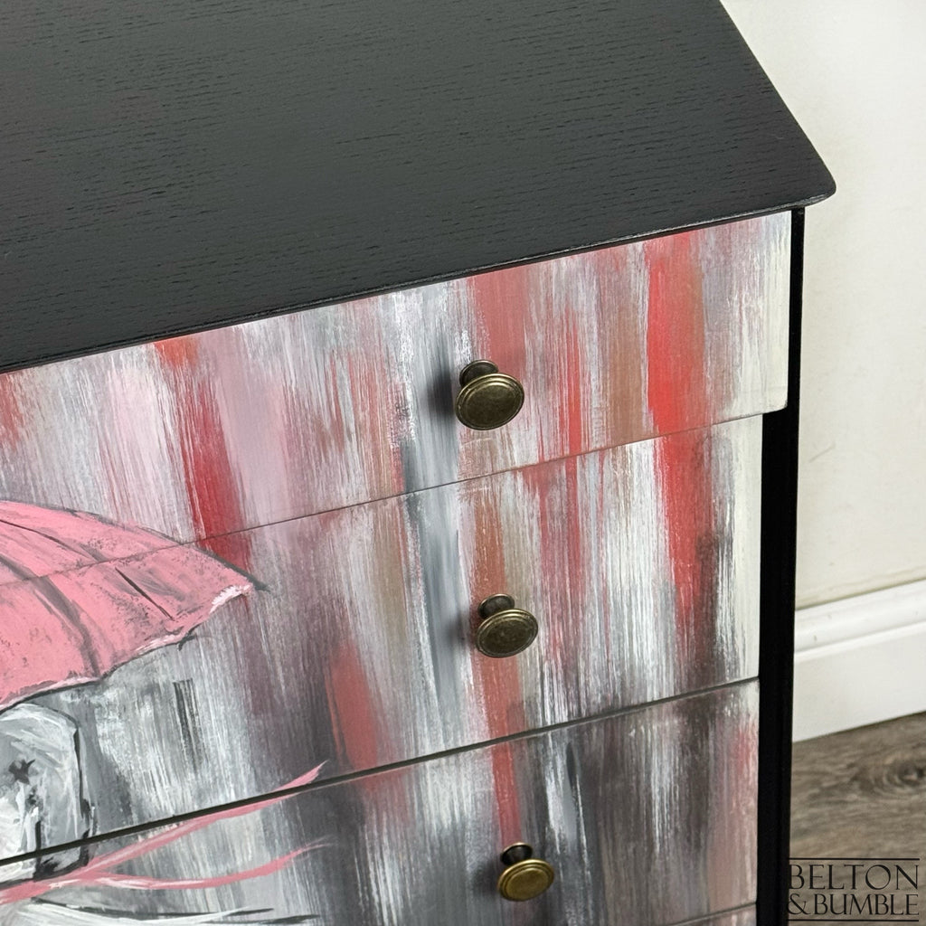 Detail of brass knobs and brushstroke texture in red, grey, and white on hand-painted drawers.