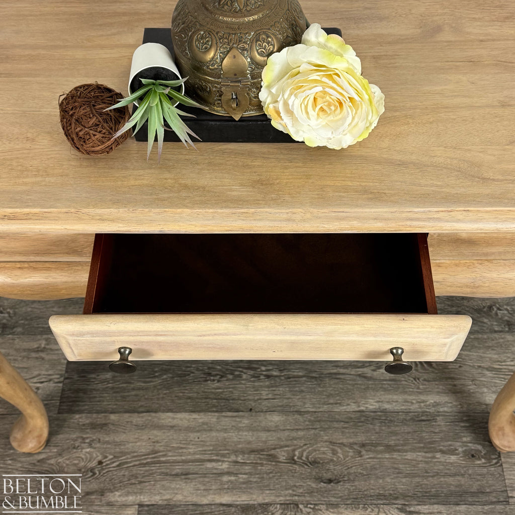 Light wood console table with single drawer partially open, revealing smooth wood interior and natural finish.