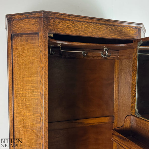Interior view of the wardrobe showing fixed hooks, spinning hooks, and the upper hanging rail.