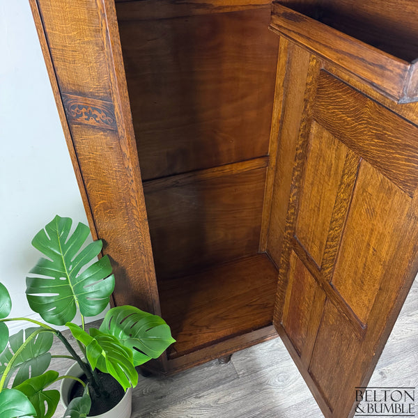 Interior lower section of the oak wardrobe, showing clean wooden base and panelling.