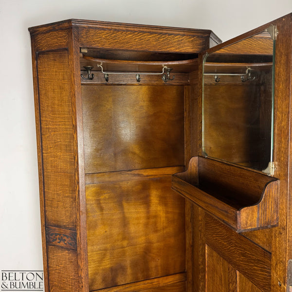 Interior view showing the vintage mirror and small built-in accessory shelf on the wardrobe door.