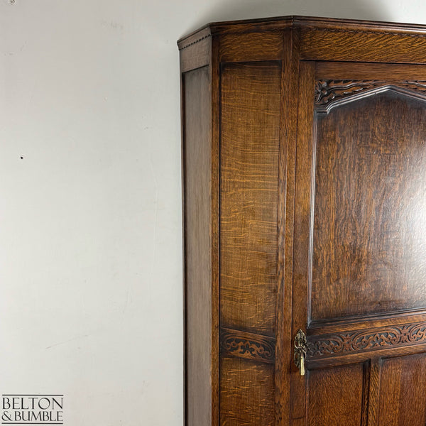 Detailed view showing the craftsmanship of the side panel and door frame on the oak wardrobe.