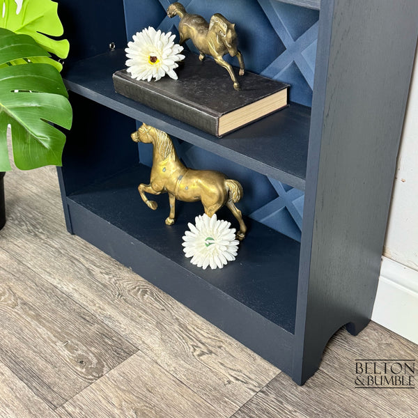 Freestanding Bookcase in Navy Blue with Adjustable Shelves — angled view showing the base of the bookcase and shape 