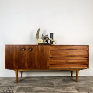 Harris Lebus Vintage English Teak Sideboard - Styled product shot with complementary decor to suggest scale