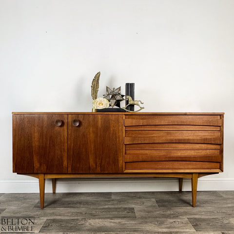 Harris Lebus Vintage English Teak Sideboard - Styled product shot with complementary decor to suggest scale