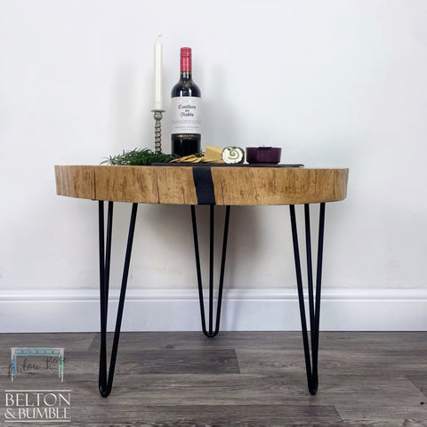 Oak Slice Black Resin Coffee Table – Styled product shot with complementary decor to suggest scale