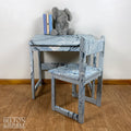 Old School Lift Lid Child’s Writing Desk and Chair in Pale Blue with Multi Coloured Details – Styled product shot with complementary decor to suggest scale