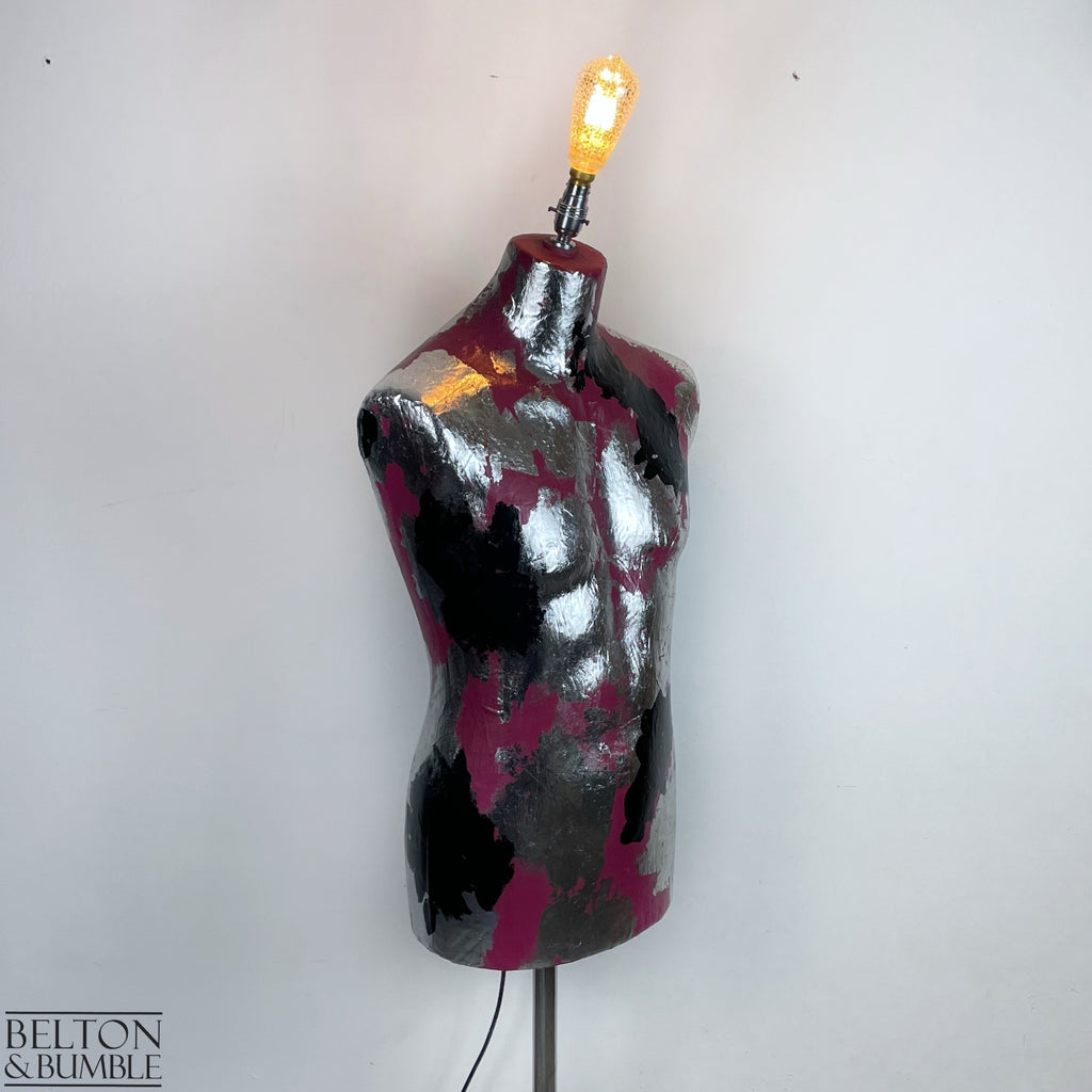 Pink Black and Silver Mannequin Lamp with Stainless Steel Stand - A mannequin floor lamp with a stainless steel stand, the mannequin has a vibrant pink base with silver and black metal leaf detailing, and a bayonet crackle smoked glass bulb.