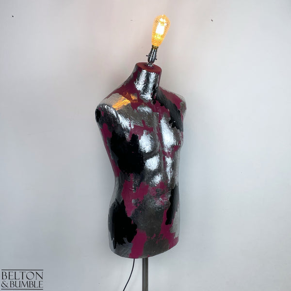 Pink Black and Silver Mannequin Lamp with Stainless Steel Stand - A mannequin floor lamp with a stainless steel stand, the mannequin has a vibrant pink base with silver and black metal leaf detailing, and a bayonet crackle smoked glass bulb.