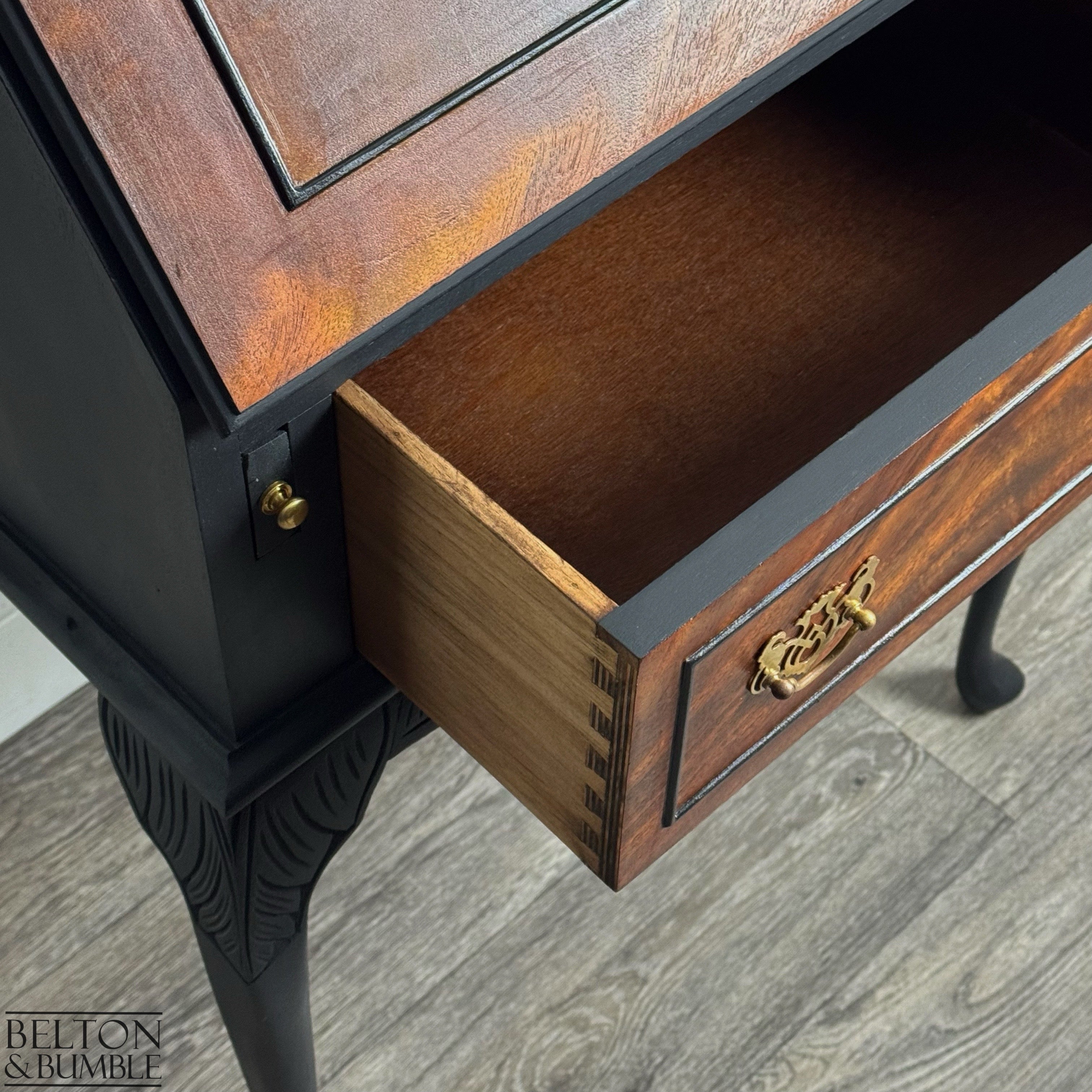 Vintage bureau with open dovetail drawer revealing natural wood interior and burr walnut veneer