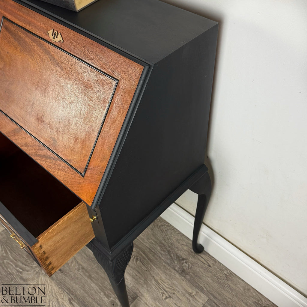 Side view of black-painted Queen Anne bureau with burr walnut front and elegant curved legs