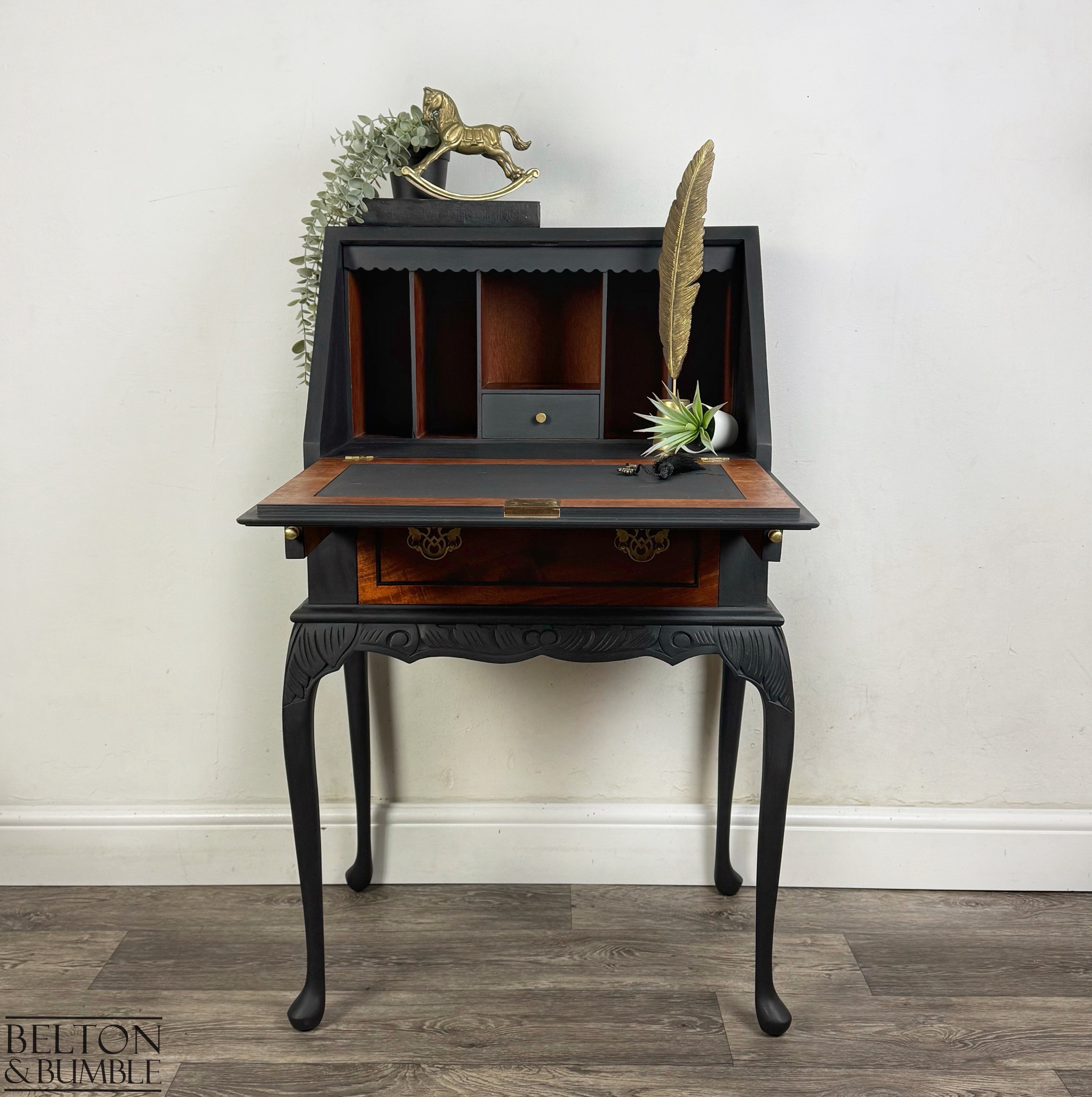 Vintage Queen Anne writing desk opened to reveal black and walnut interior with compartments and drop-front surface