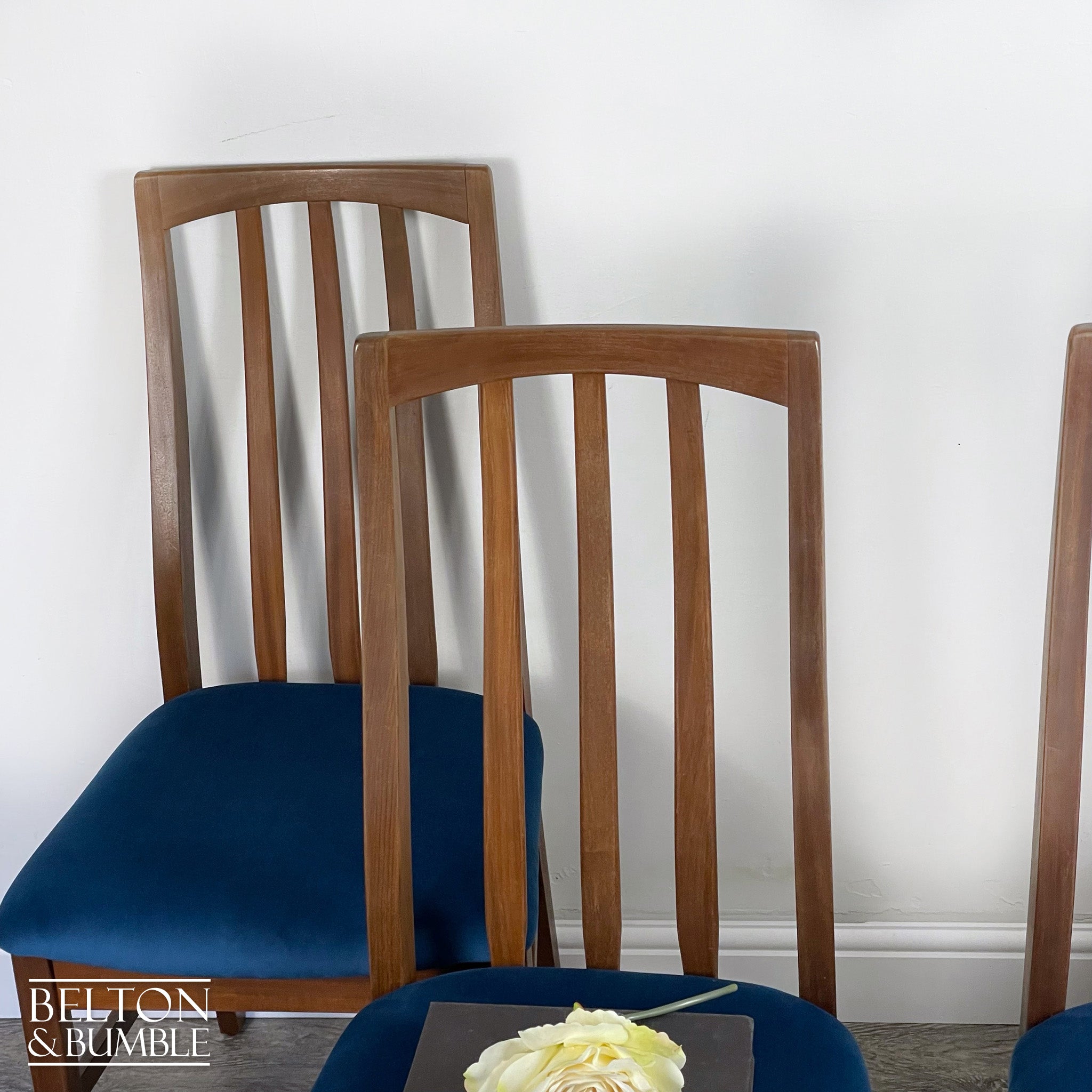 Set of Four Teak Dining Chairs with Navy Velvet – Restored vintage piece with teak and navy accents and upholstered seat, wooden legs