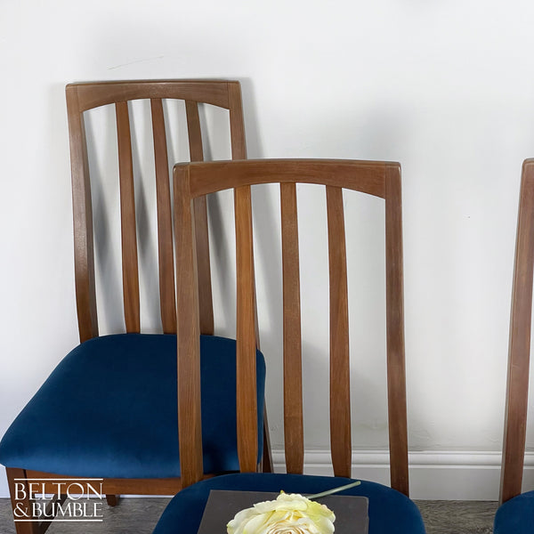 Set of Four Teak Dining Chairs with Navy Velvet – Restored vintage piece with teak and navy accents and upholstered seat, wooden legs