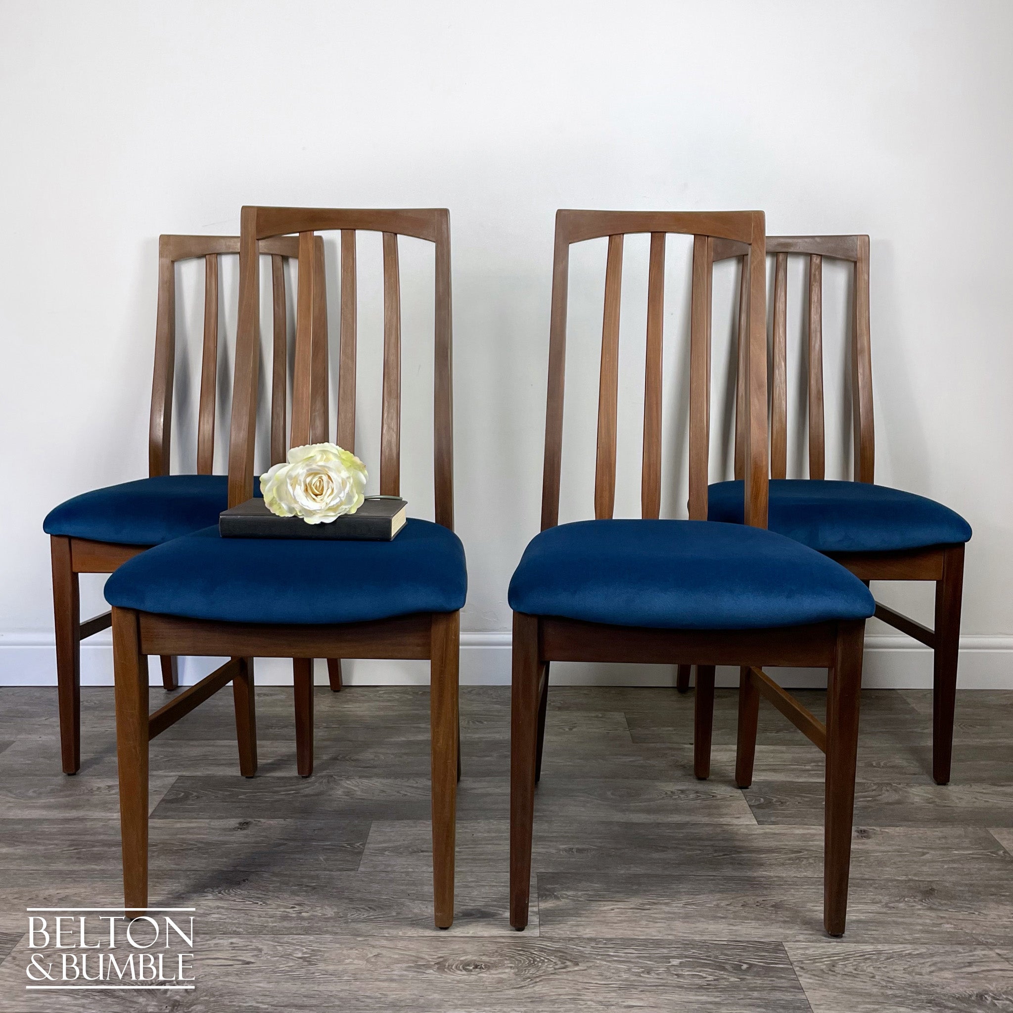 Set of Four Teak Dining Chairs with Navy Velvet – Styled product shot with complementary decor to suggest scale