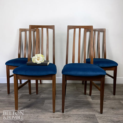 Set of Four Teak Dining Chairs with Navy Velvet – Styled product shot with complementary decor to suggest scale