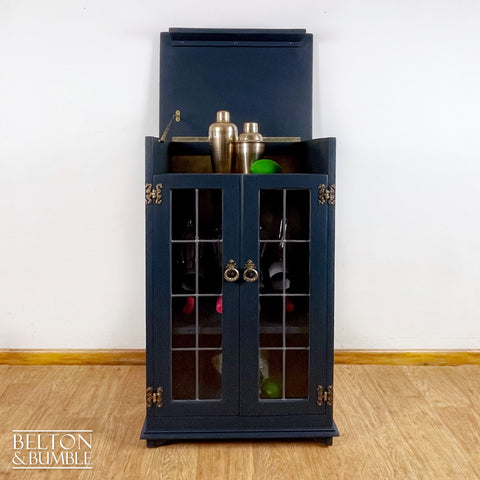 Solid Wood Carved Navy and Gold Cocktail Drinks Cabinet – Styled product shot with complementary decor to suggest scale