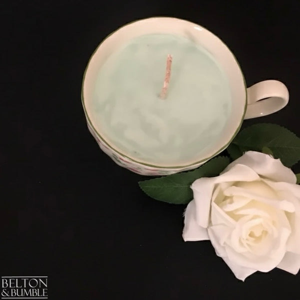 Soy Wax Vintage Teacup Candles with Green Apple Scent - Overhead view of a pale green soy wax candle in a vintage teacup, styled with a white rose for a fresh, elegant look.