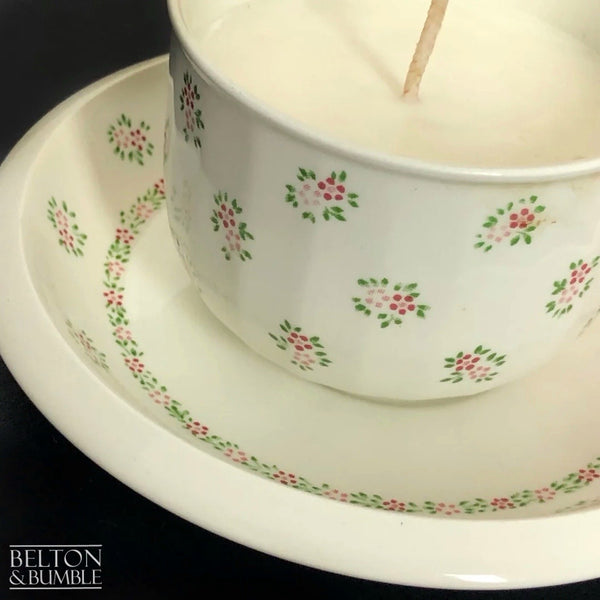 Soy Wax Vintage Teacup and Saucer Candle with Vanilla Scent - Vanilla soy wax teacup candle displayed on its matching saucer, styled with a soft pink daisy flower.