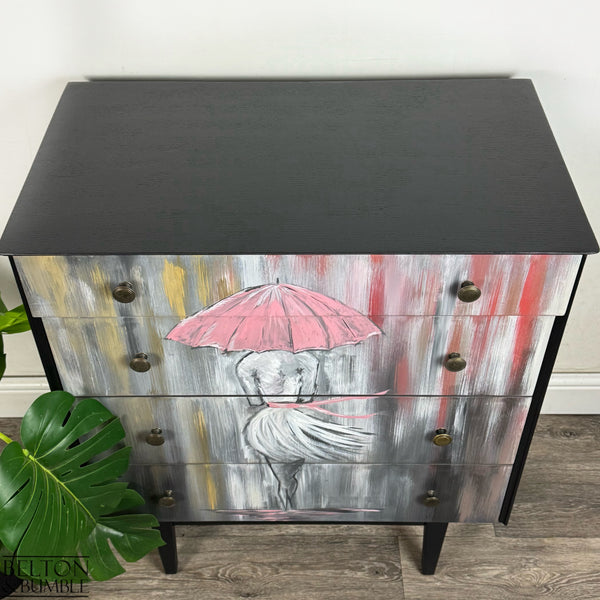 Overhead view showing smooth matte black top and painted umbrella artwork on drawers.
